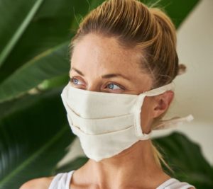 This reusable cotton face mask is made from white organic cotton and has two ties.