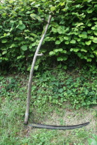 Scythe_against_hedge