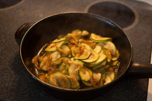 zucchini cooking with onions